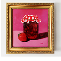 A framed painting of a glass jar of jam with a red-and-white checkered cloth lid and a strawberry on a pink background, enclosed in an ornate gold frame.